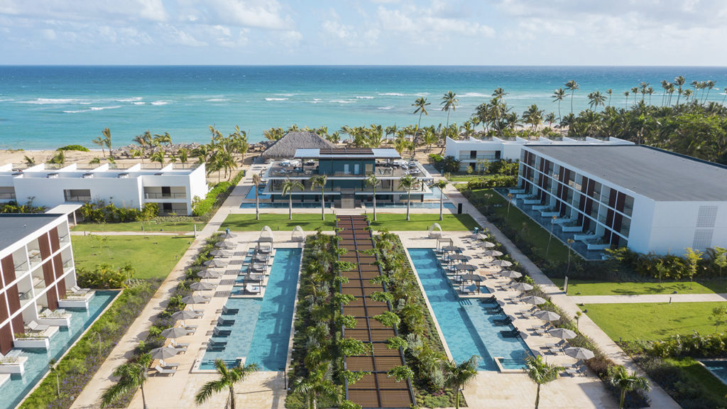 Vista frontal do Live Aqua Beach Resort Punta Cana, com piscina e frente para o mar.